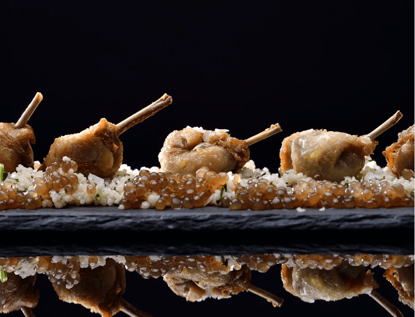 Cosce di quaglia con cuscus di porcini e perle di tartufo